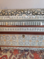 Decorative wooden box with intricate patterns on a plain background