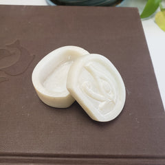 White soapstone box with an eye symbol on a brown surface
