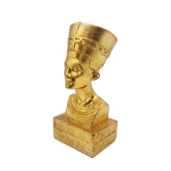Gold-colored statue of a pharaoh on a white background