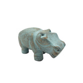 Decorative hippo figure with a textured surface on a white background
