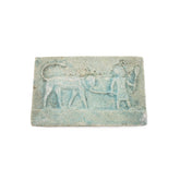 Ancient stone tablet with relief of a figure and animal on a white background