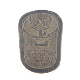Decorative stone with winged symbol and hieroglyphics on a white background