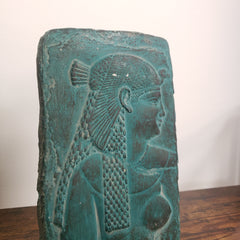 Decorative Cleopatra wall hanging with intricate carvings on a wooden surface