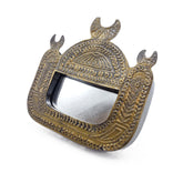 Decorative brass framed mirror with intricate design on a white background