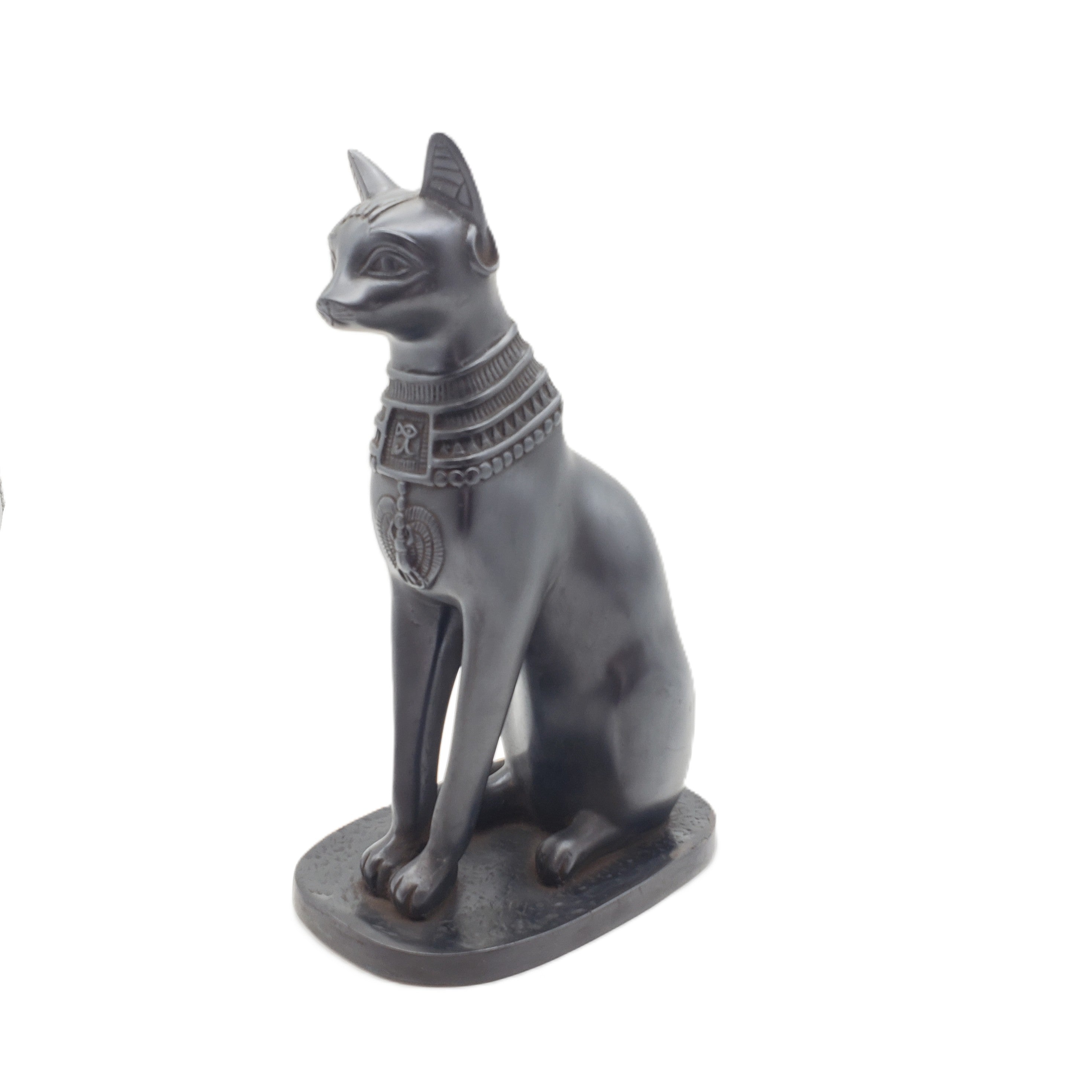 Statue of a cat with Egyptian-style jewelry on a white background