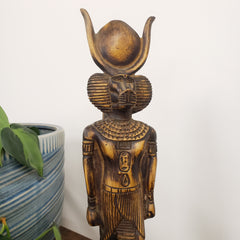 Statue of a deity with a headdress on a white background