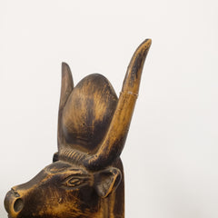 Wooden bull head sculpture on a white background