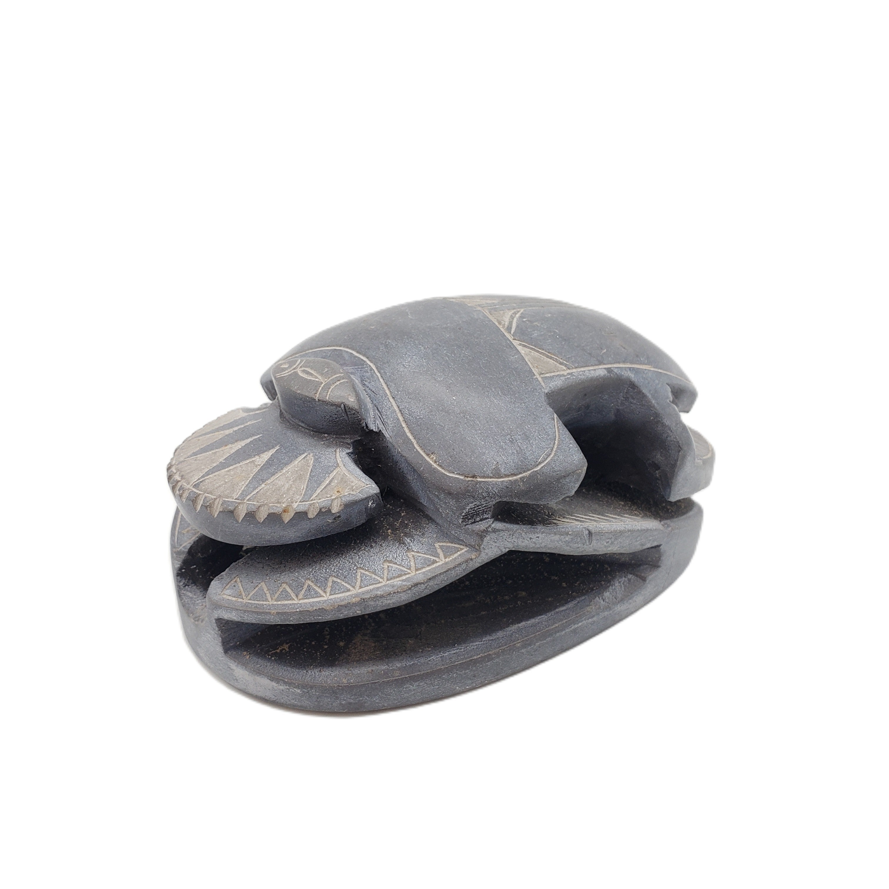 Decorative stone sculpture of a scarab on a white background