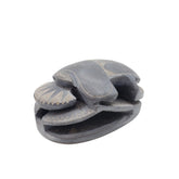 Decorative stone sculpture of a scarab on a white background