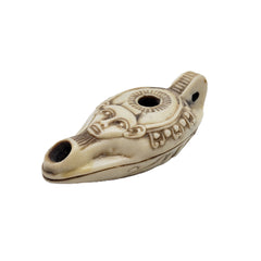 Decorative ceramic oil lamp with intricate designs on a white background