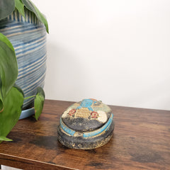 Decorative Egyptian scarab statue with intricate design on a wooden surface