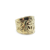 Gold ring with floral design on a white background