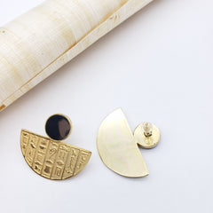 Gold earrings with half-circle design on a white background