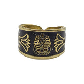 Ring with gold pharaoh design on a black background