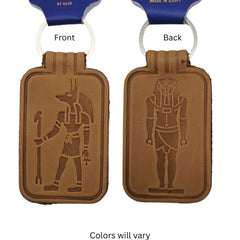 One tan leather keychains shown Front and Back, each with a white key loop. The front side features an embossed Anubis figure, and the back side features a pharaoh figure.