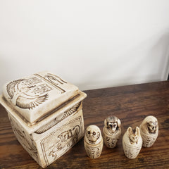 Decorative items with hieroglyphic designs on a wooden surface