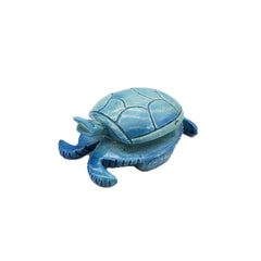 Blue turtle-shaped decorative item on a white background