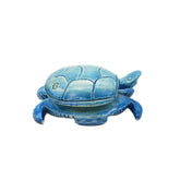 Blue turtle-shaped object on a white background