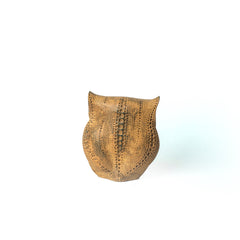 Decorative statue with a textured pattern on a white background