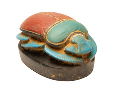 Decorative beetle figure with red, green, and blue colors on a white background