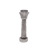 Decorative silver column with intricate designs on a white background