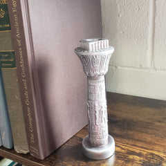 Decorative object on top of a book with a brick wall background