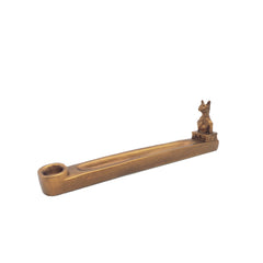 Bronze-colored incense holder with a small figurine on a white background