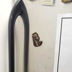 Black and gold Cleopatra magnet on a refrigerator