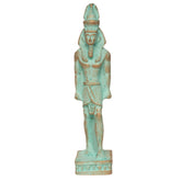 An ancient Egyptian pharaoh statue with a light turquoise-green patina and distressed brown highlights, standing on a decorative base against a plain white background.