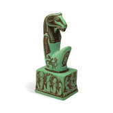 Green Egyptian-style figurine on a white background