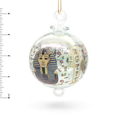 Decorative glass ball with Egyptian-themed design on a white background