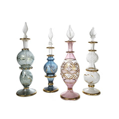 Set of four decorative glass bottles with intricate designs on a white background