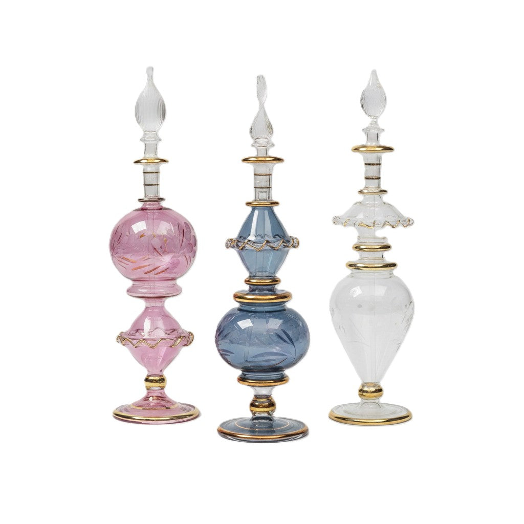Three decorative vases in pink, blue, and white with gold accents on a white background