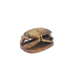 Egyptian scarab figurine on a white background
