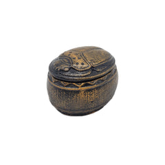 Decorative beetle-shaped box with intricate designs on a white background