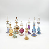 Collection of colorful glass perfume bottles on a white background