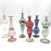 Set of colorful glass perfume bottles on a white background