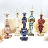 Set of colorful glass bottles with intricate designs on a white background