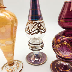 Three ornate glass vases with intricate designs on a white background