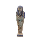 Decorative figurine resembling an ancient Egyptian mummy with blue and brown colors on a white background