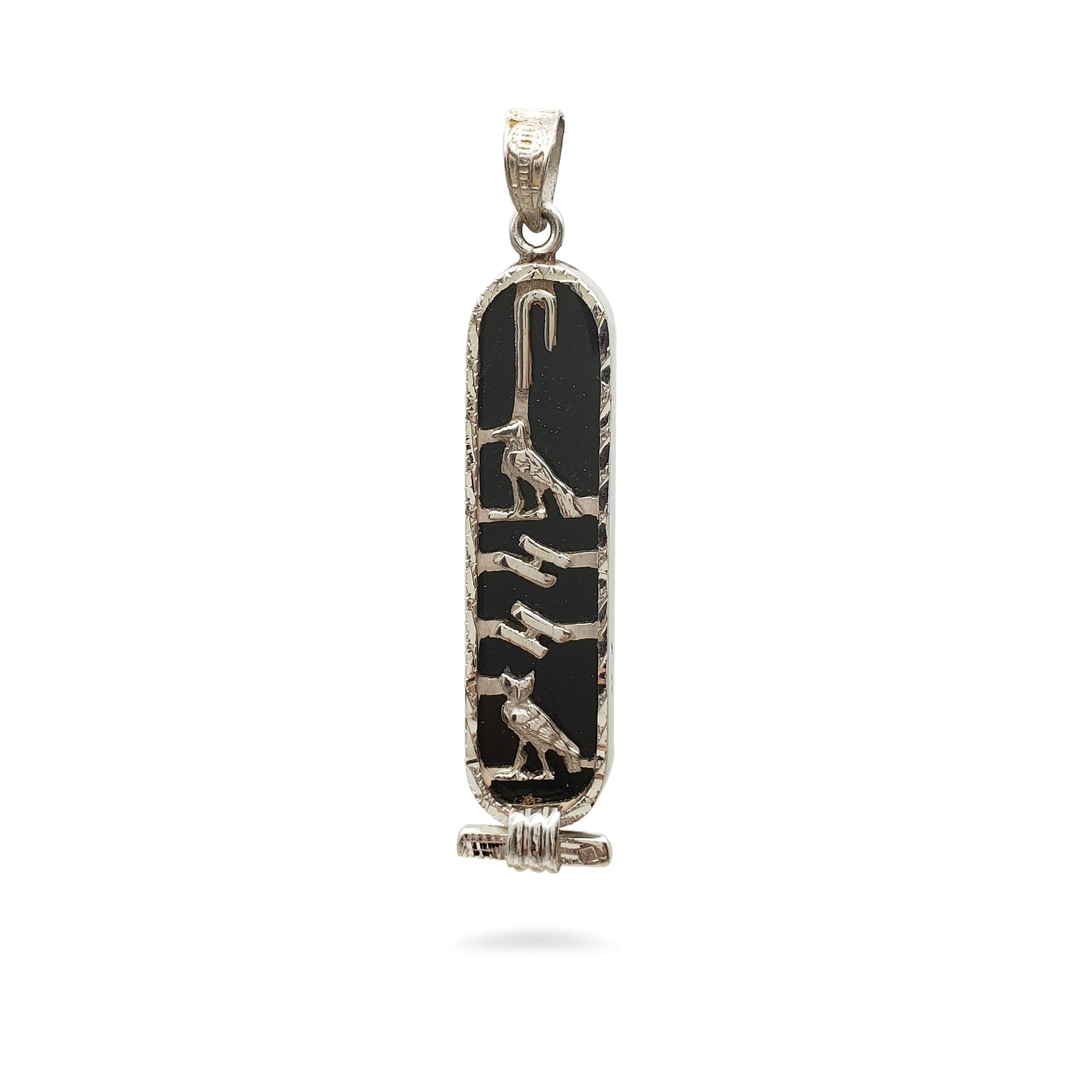 Decorative pendant with black and gold design on a white background