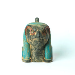 Decorative Egyptian figurine with turquoise and gold accents on a white background