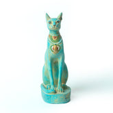 Turquoise cat figurine with gold accents on a white background