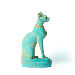 Turquoise Egyptian-style cat figurine on a white background