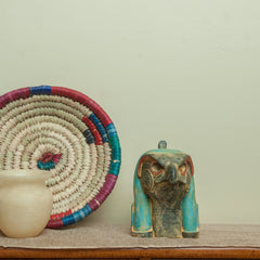 Decorative items on a wooden dresser against a plain wall