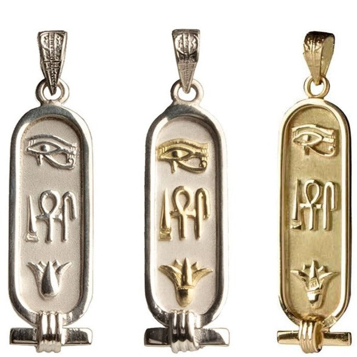 Three cartouche pendants with hieroglyphic symbols for 'Health, Life, & Happiness', featuring the Eye of Horus, a middle symbol, and a lotus flower at the bottom, in varying metal colors.