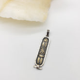 Decorative pendant with hieroglyphics on a light background
