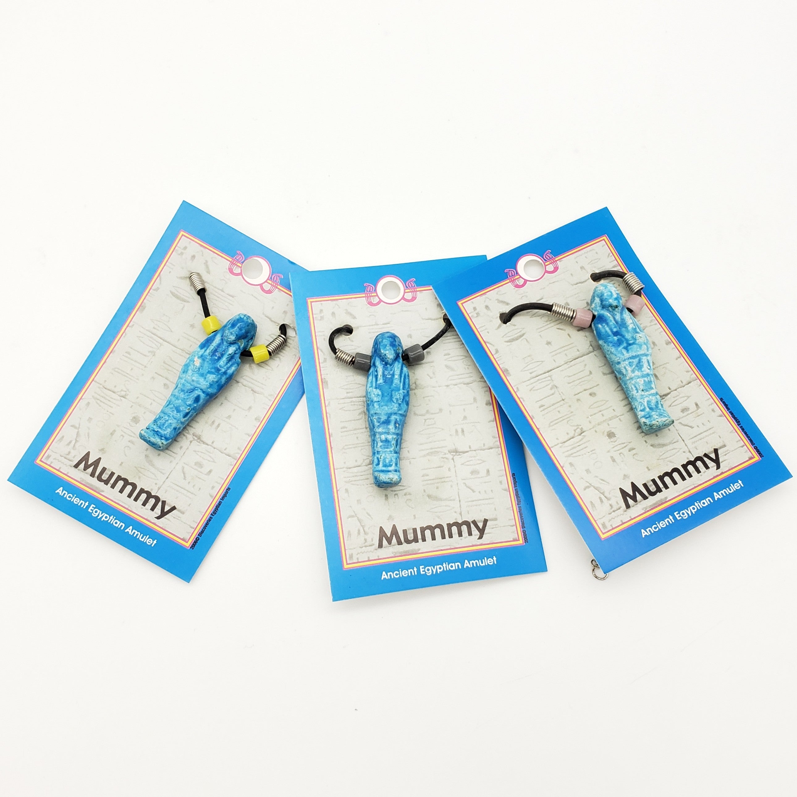 Three blue mummy-shaped amulets on cards with 'Mummy' text on a white background