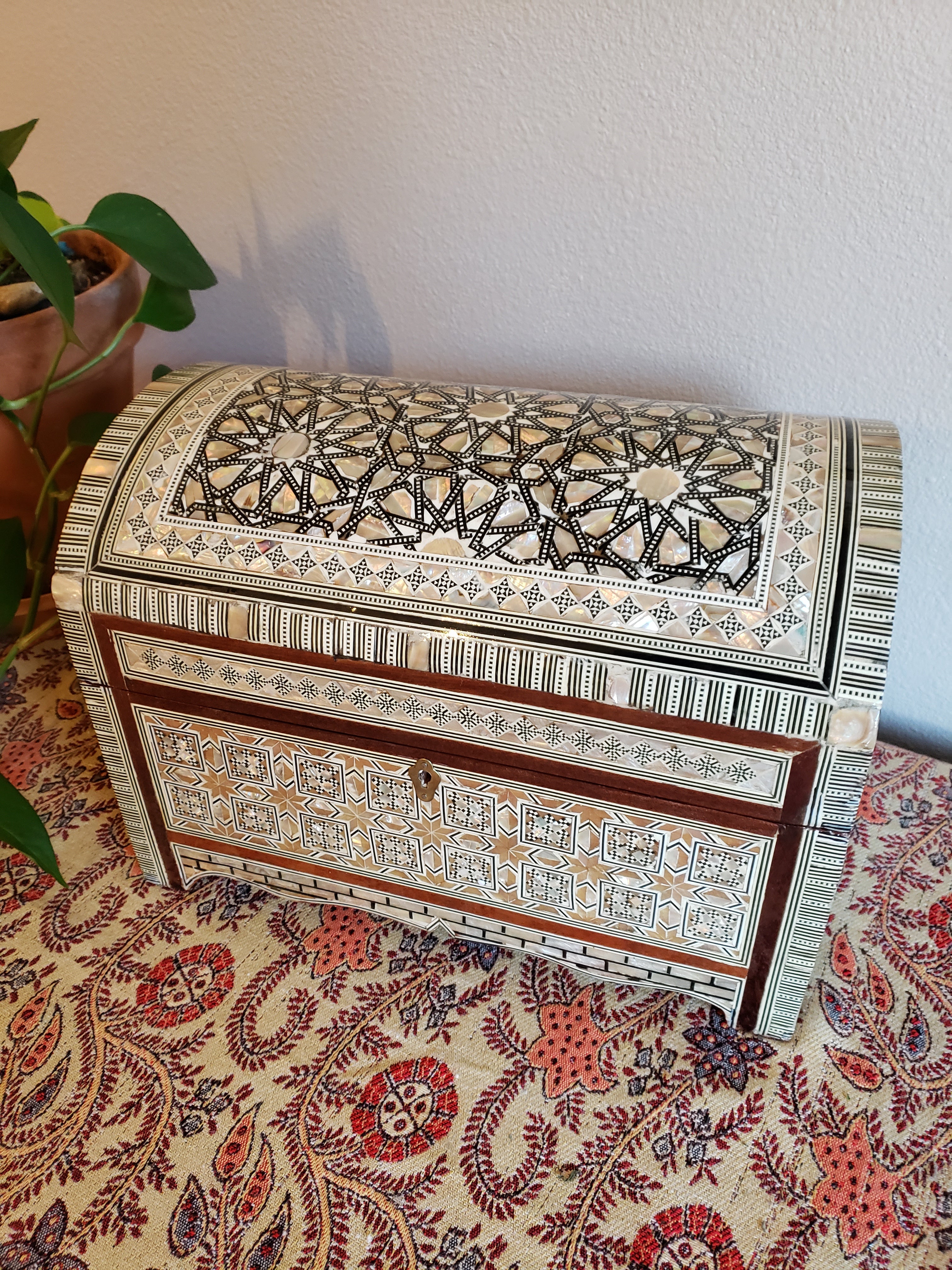 Decorative book with intricate patterns on a floral-patterned surface