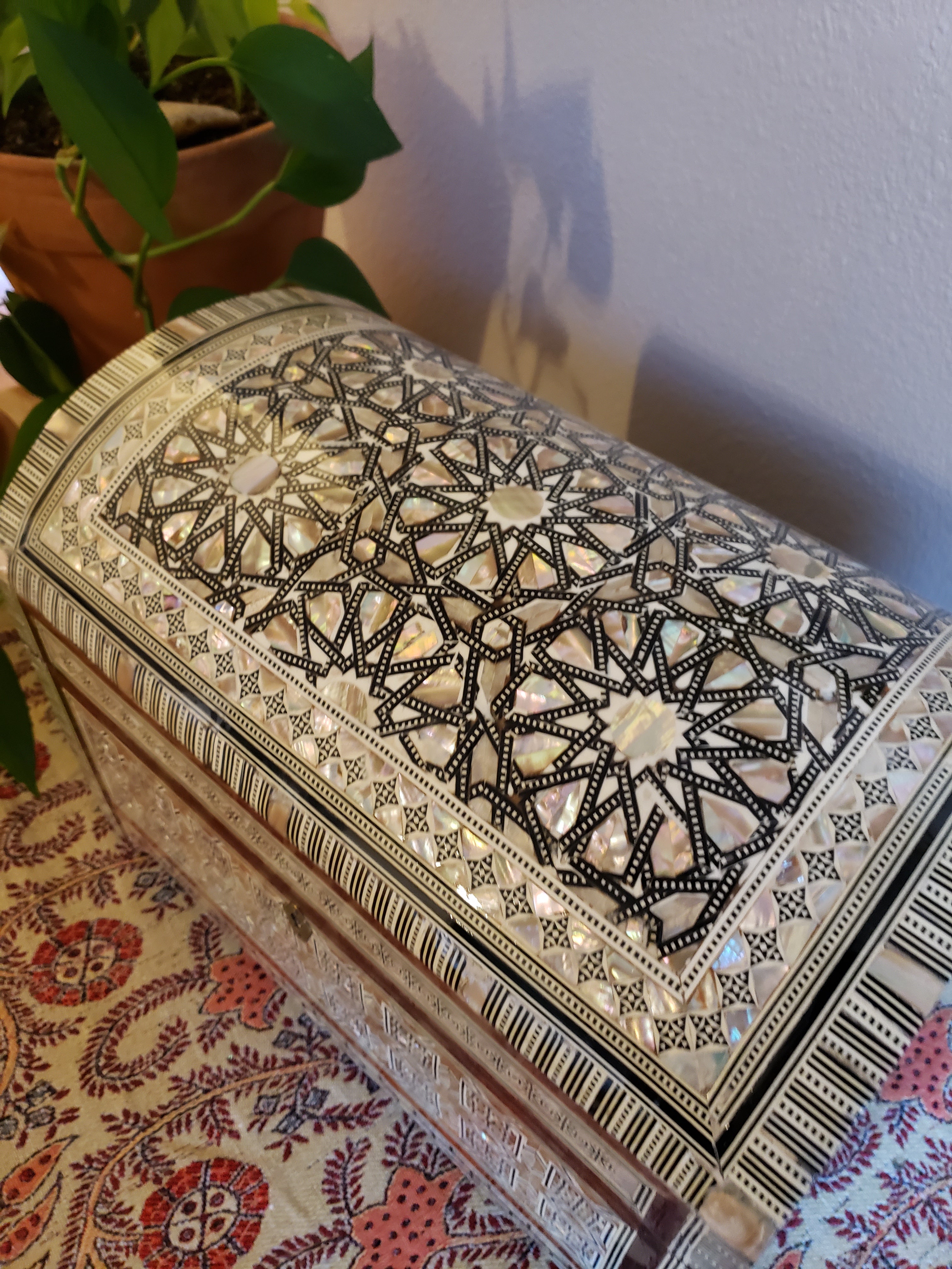 Decorative box with intricate patterns on a textured surface